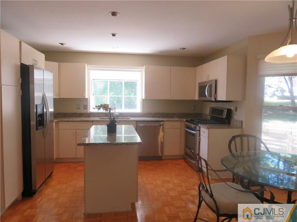 55 Primrose Circle Princeton, NJ 08540 - Photo 9 of 24 a kitchen with kitchen island granite countertop a sink appliances cabinets and a window