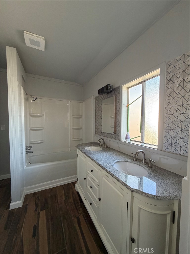 2521 P Bakersfield, CA 93301 - Photo 12 of 21 a bathroom with a granite countertop double vanity sink a mirror and a bathtub