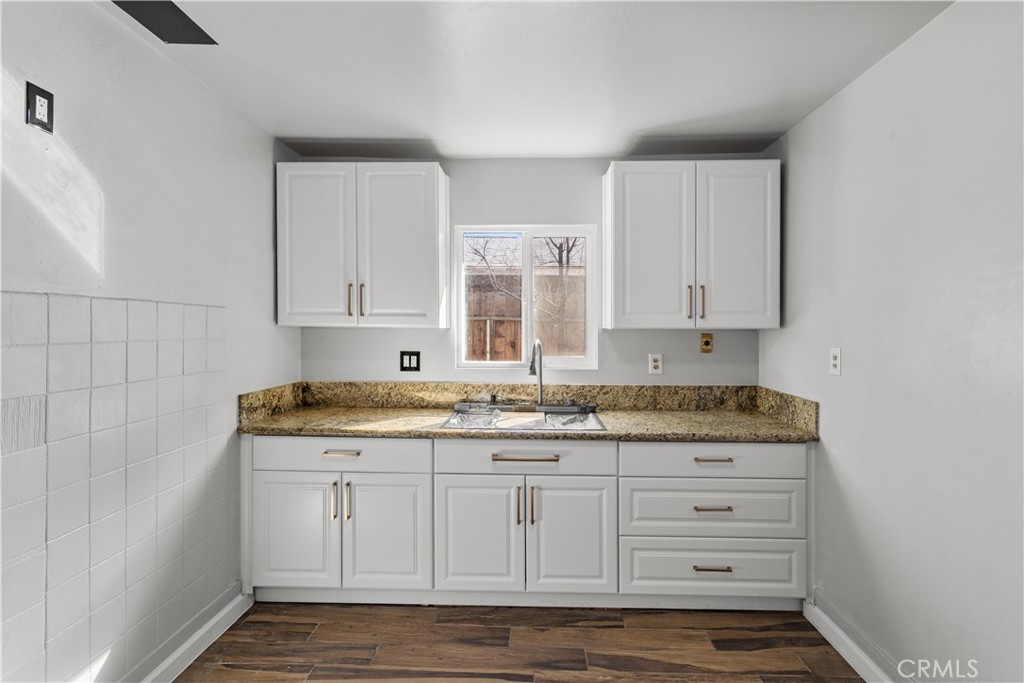 2521 P Bakersfield, CA 93301 - Photo 8 of 21 a kitchen with granite countertop white cabinets and sink