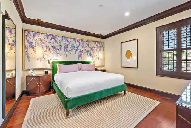 a bedroom with a large bed and a flat screen tv