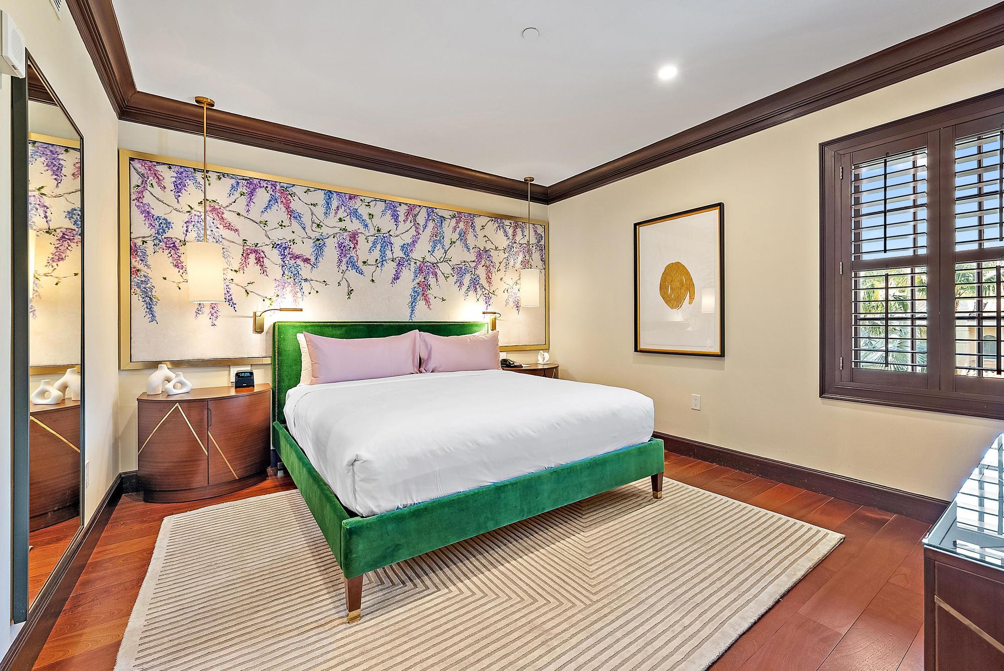 301 Australian Avenue, Unit 301 Palm Beach, FL 33480 - Photo 11 of 26 a bedroom with a bed lamp and a large window with wooden floor