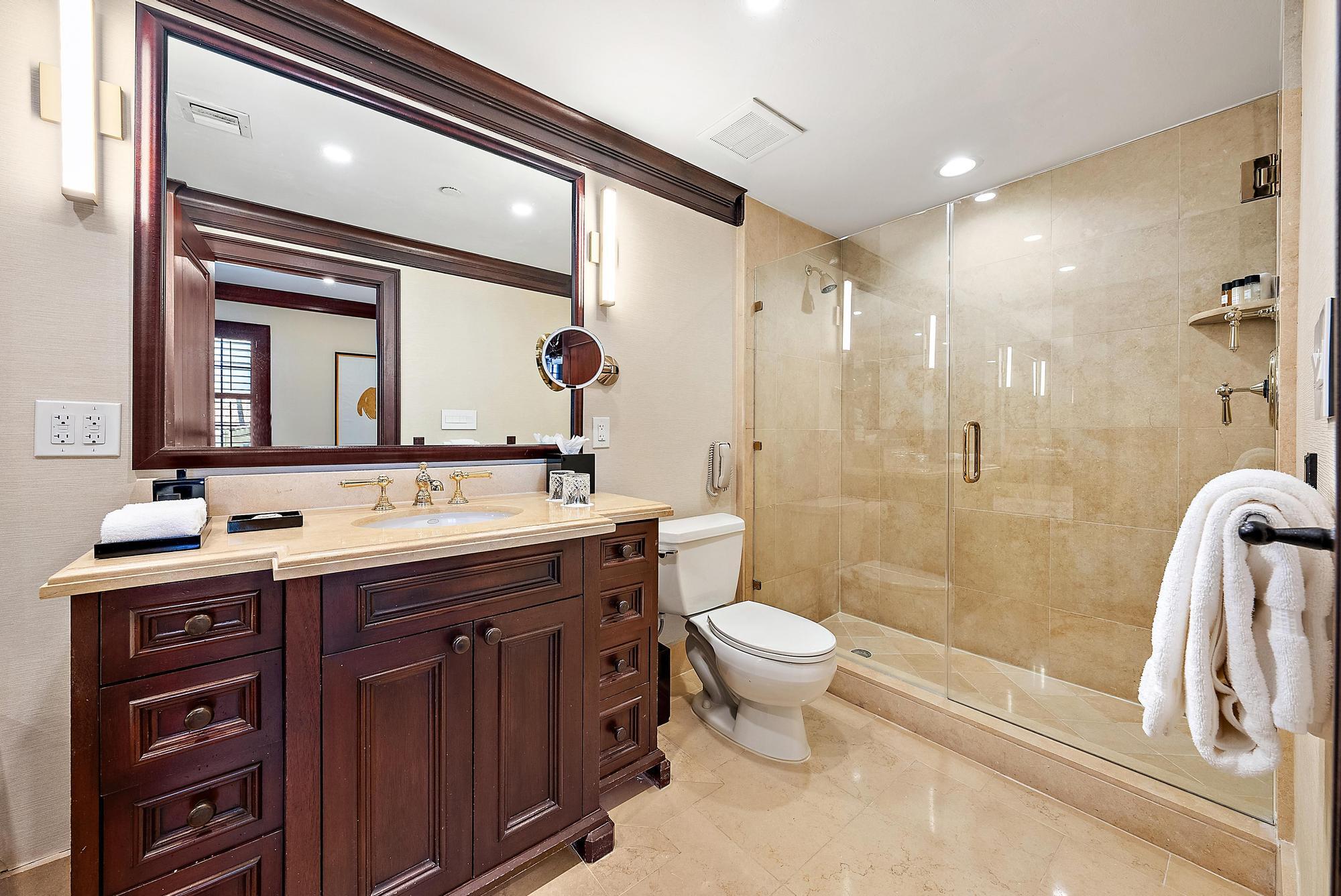 301 Australian Avenue, Unit 301 Palm Beach, FL 33480 - Photo 13 of 26 a bathroom with a double vanity sink mirror and toilet