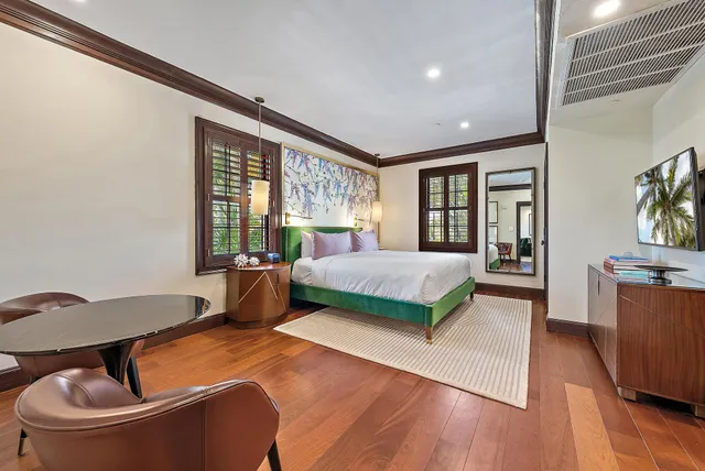 a bedroom with a large bed and a large window