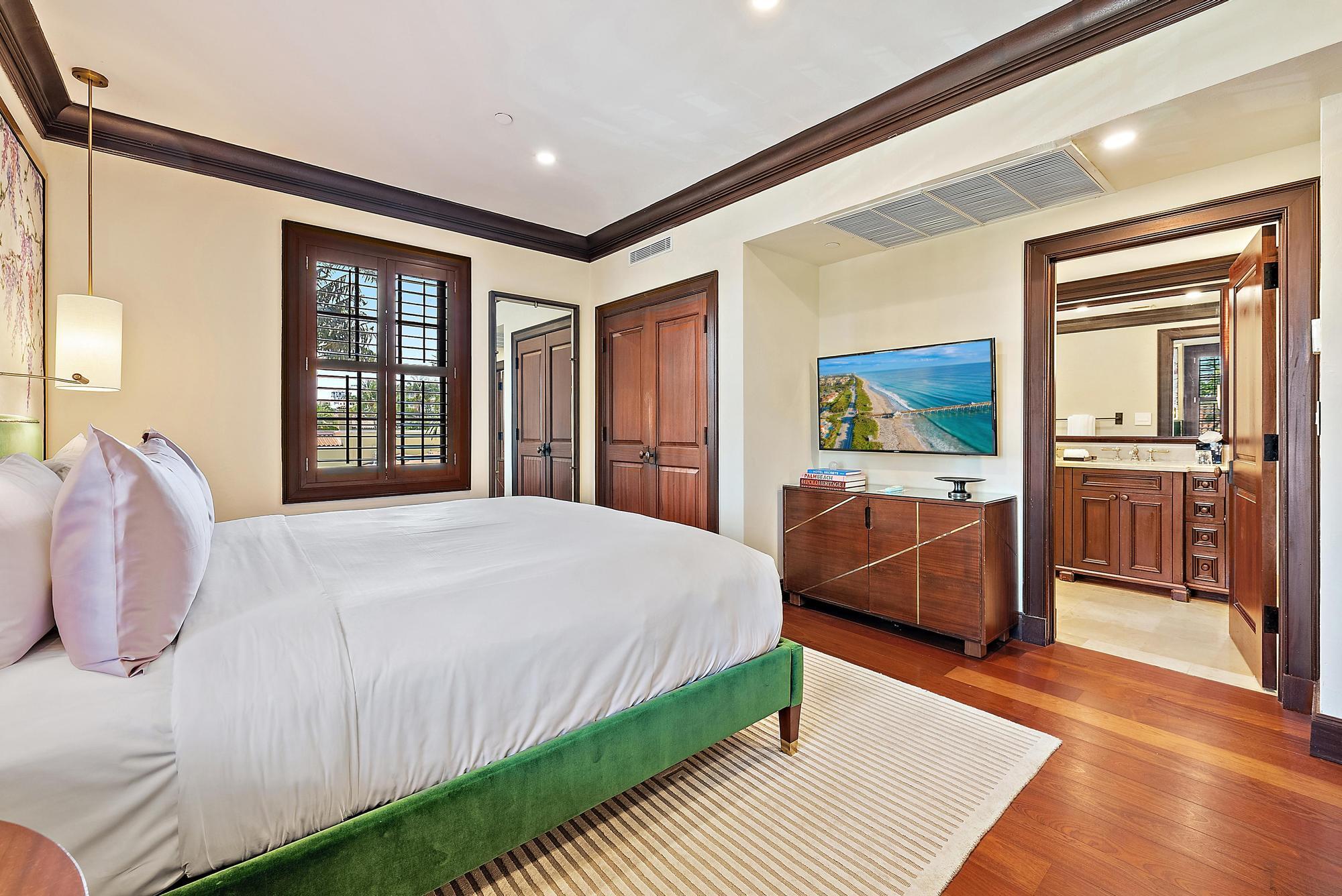 301 Australian Avenue, Unit 301 Palm Beach, FL 33480 - Photo 15 of 26 a bedroom with a large bed and a large window