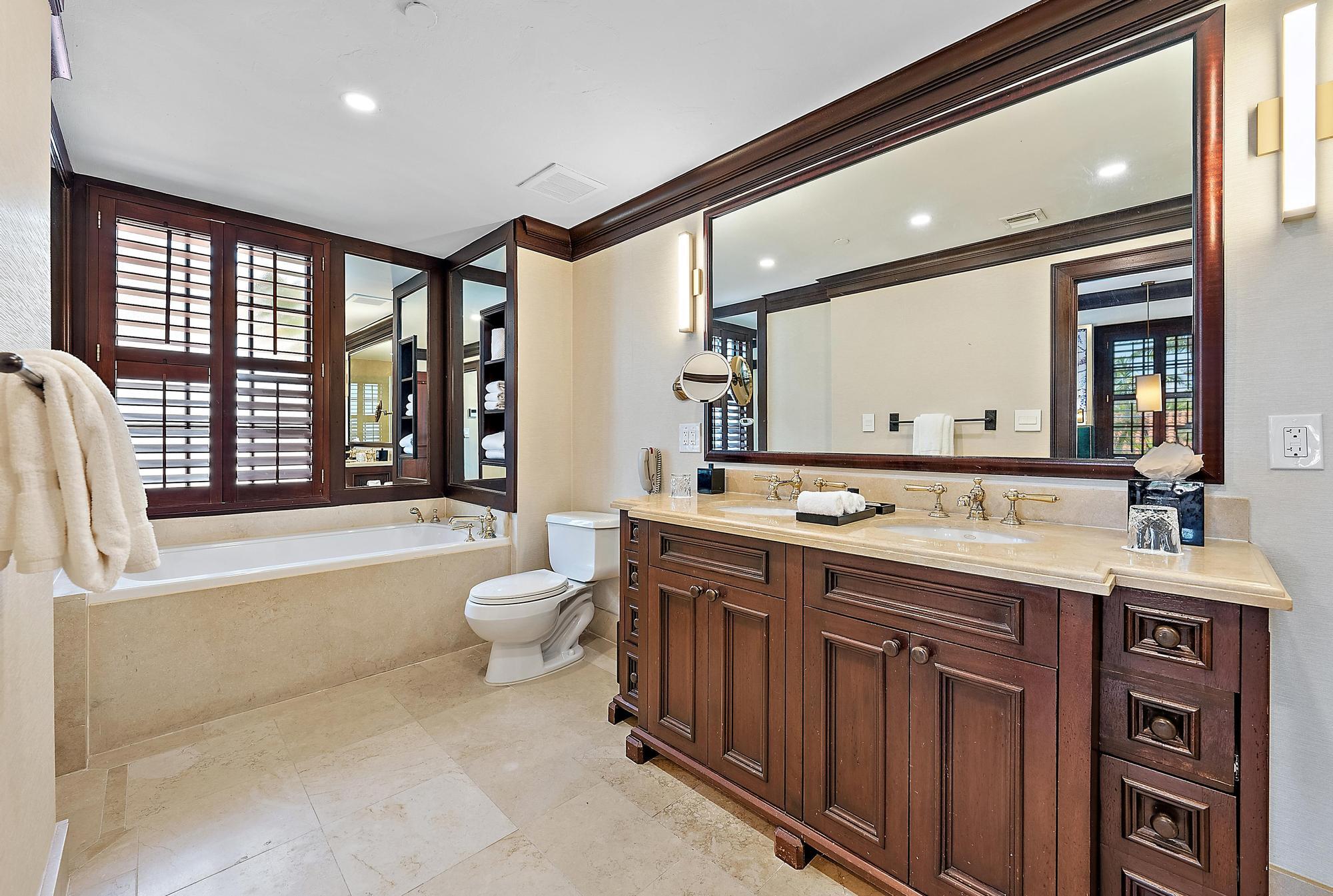 301 Australian Avenue, Unit 301 Palm Beach, FL 33480 - Photo 16 of 26 a spacious bathroom with a double vanity sink a large mirror and a toilet