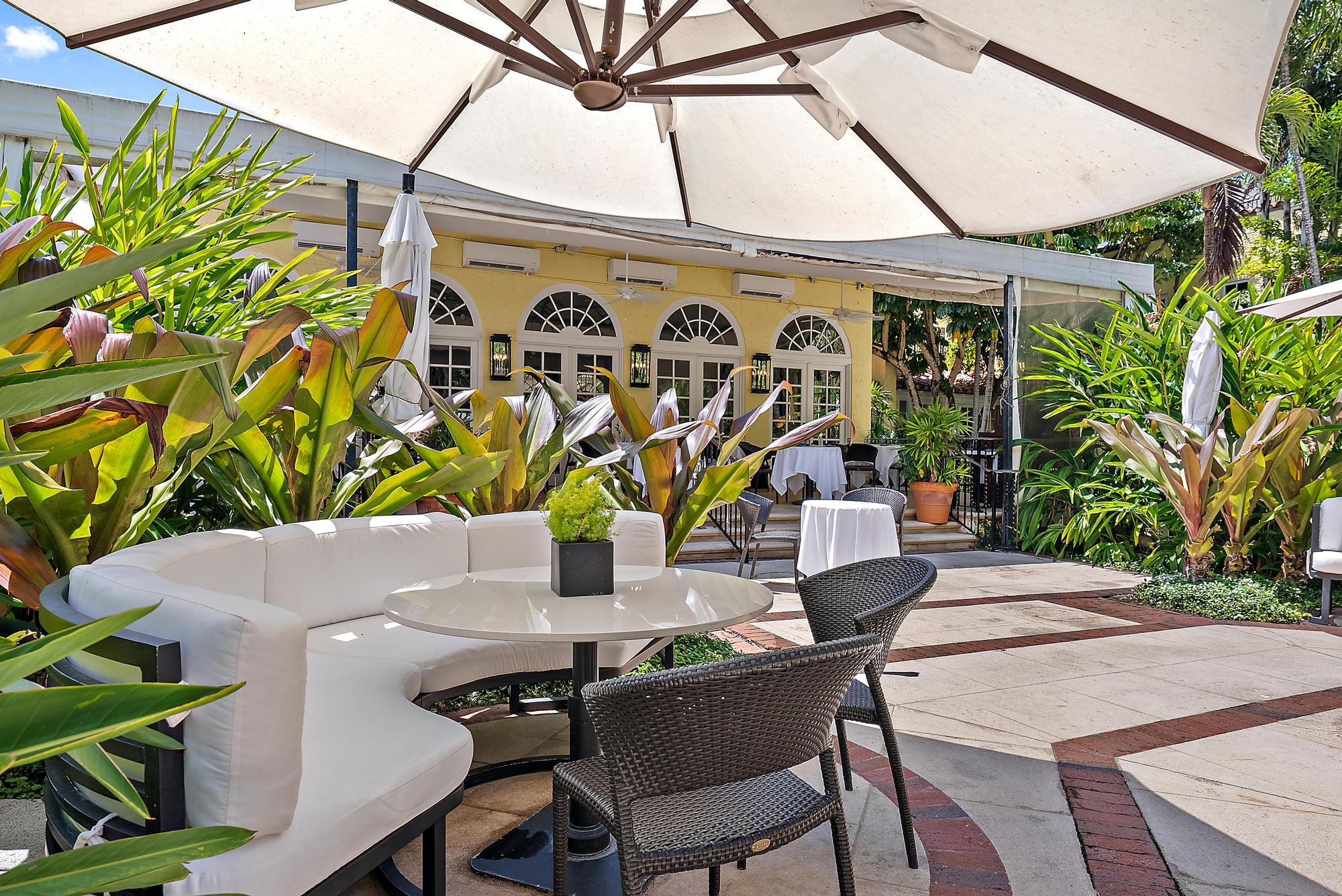 301 Australian Avenue, Unit 301 Palm Beach, FL 33480 - Photo 23 of 26 a view of a patio with table and chairs and potted plants