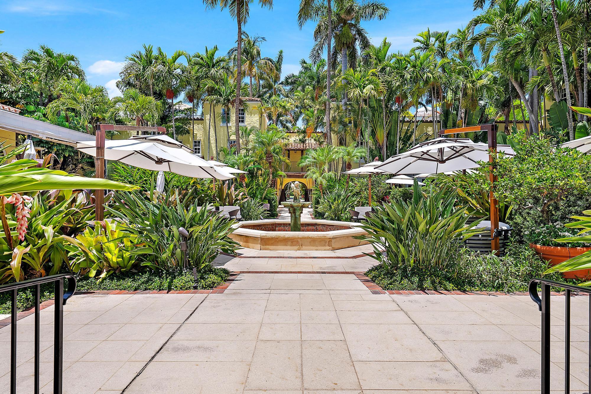 301 Australian Avenue, Unit 301 Palm Beach, FL 33480 - Photo 4 of 26 a view of swimming pool with lawn chairs and a potted plant