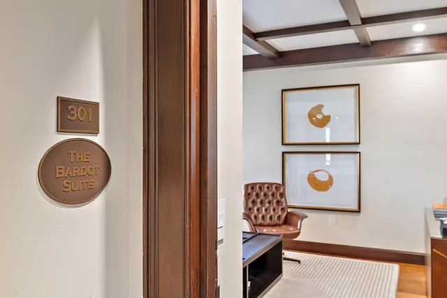 a living room with patio furniture and wooden floor