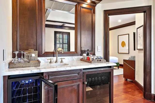 a bedroom with a bed lamp and a large window with wooden floor