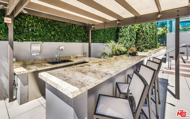 a outdoor living space with patio furniture and a fireplace