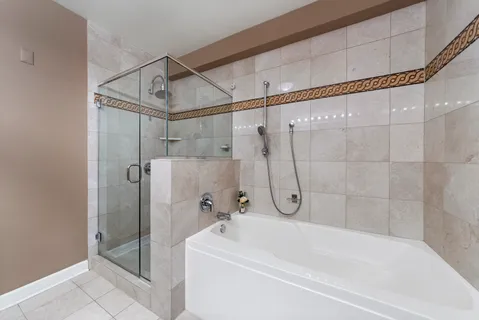 a bathroom with a white bath tub with shower