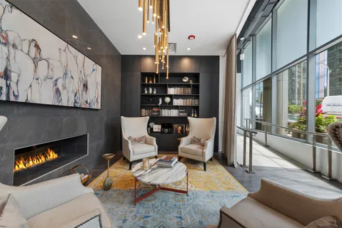 a living room with furniture fireplace and rug