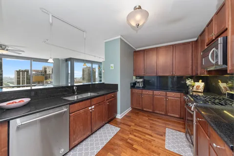 a kitchen with granite countertop a sink and cabinets