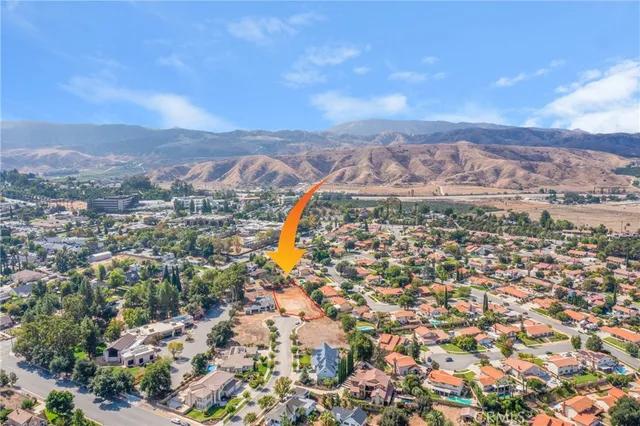 an aerial view of residential building with green space