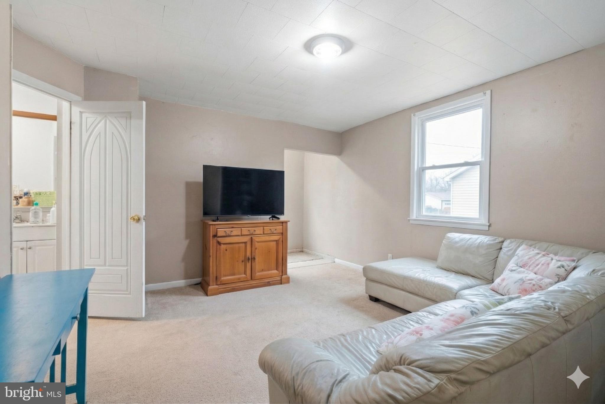 16700 Frederick Road Mount Airy, MD 21771 - Photo 26 of 45 a living room with furniture and a flat screen tv