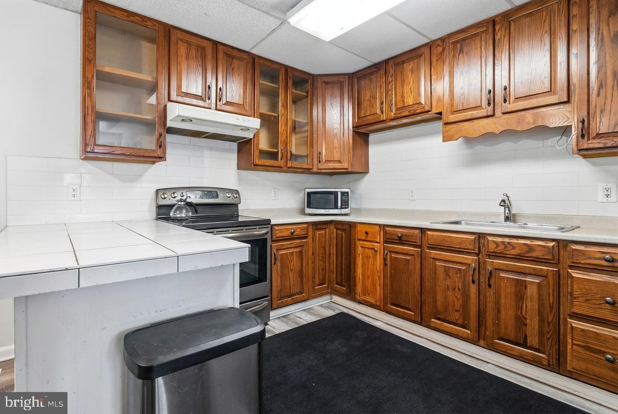 16700 Frederick Road Mount Airy, MD 21771 - Photo 33 of 45 a kitchen with granite countertop wood cabinets stainless steel appliances and a sink