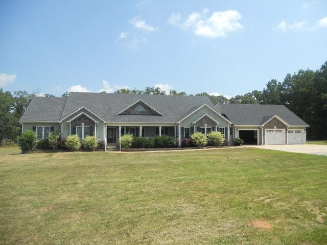 2003 East Milner Road, Unit 5 Zebulon, GA 30295 - Photo 1 of 1 a front view of a house with a garden