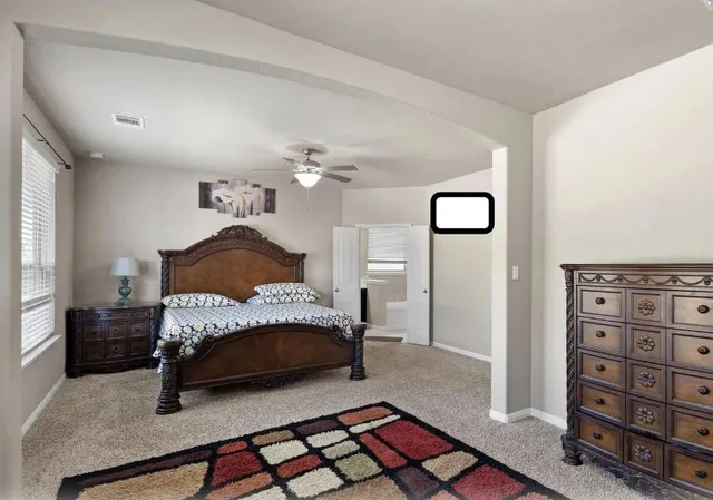 a bedroom with a bed and window