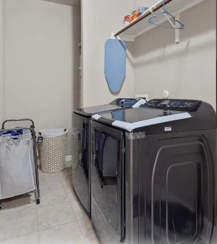 a bathroom with a double vanity sink a tub and a mirror