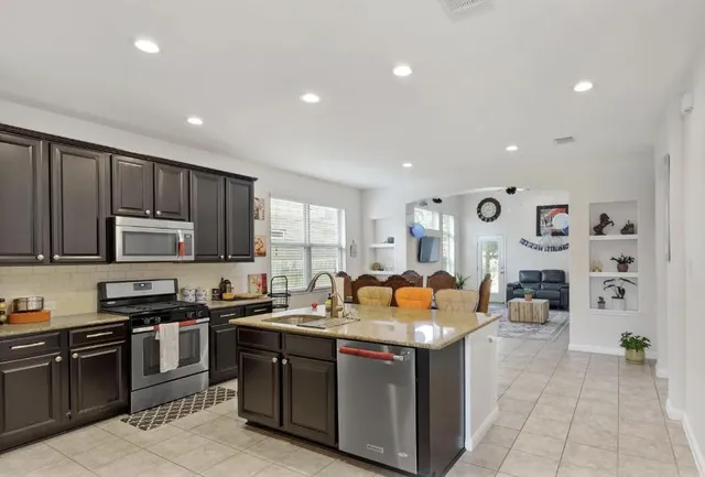 a backyard of a house with table and chairs