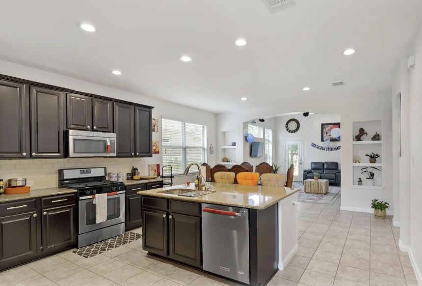 2781 Santa Ana Lane Round Rock, TX 78665 - Photo 21 of 22 a kitchen with stainless steel appliances granite countertop a stove a sink and a refrigerator