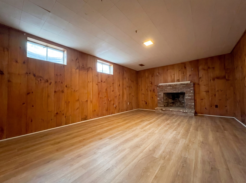 16 Crest Drive Dover, MA 02030 - Photo 12 of 24 a view of empty room with wooden floor and fireplace