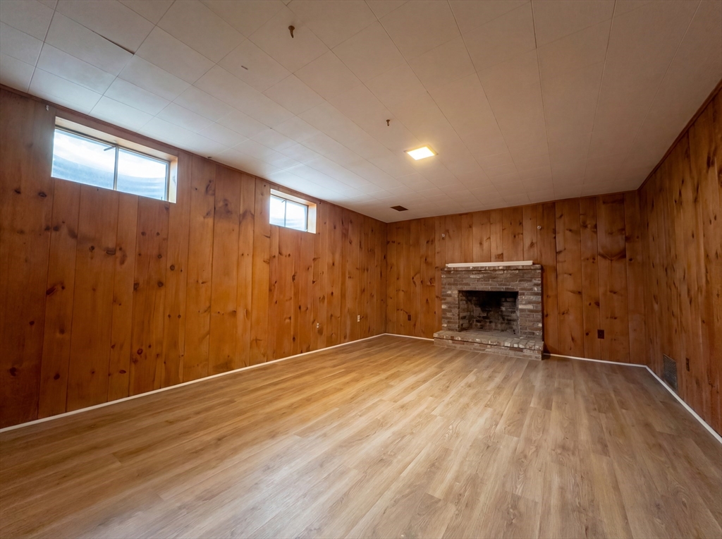 16 Crest Drive Dover, MA 02030 - Photo 13 of 24 a view of empty room with wooden floor and fireplace