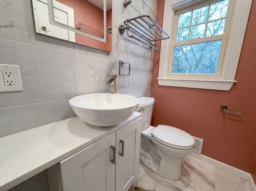 16 Crest Drive Dover, MA 02030 - Photo 19 of 24 a bathroom with a toilet a sink and a window