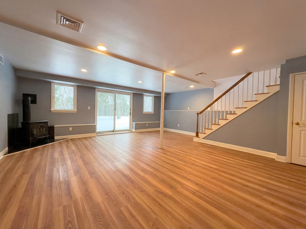 16 Crest Drive Dover, MA 02030 - Photo 20 of 24 a view of an empty room with wooden floor and a window
