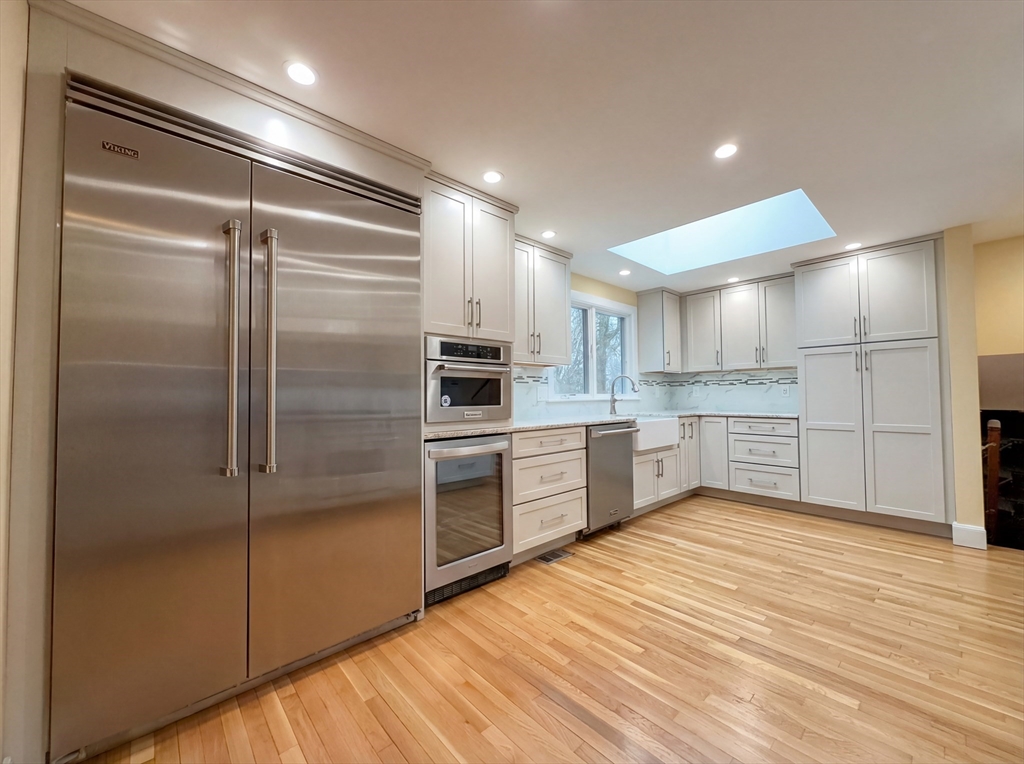 16 Crest Drive Dover, MA 02030 - Photo 2 of 24 a large kitchen with a refrigerator and white cabinets