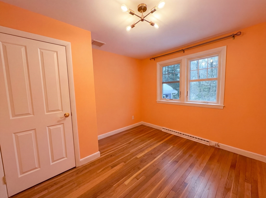16 Crest Drive Dover, MA 02030 - Photo 6 of 24 a view of empty room with wooden floor and fan