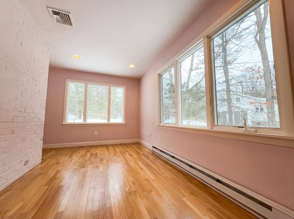 16 Crest Drive Dover, MA 02030 - Photo 10 of 24 a view of an empty room with a window and wooden floor