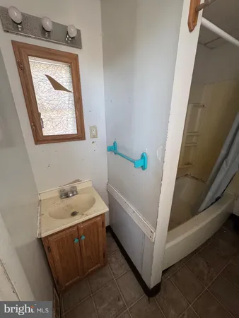 a bathroom with a sink window and tub