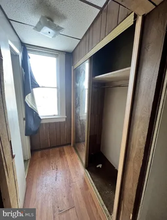 a view of entryway with window and wooden floor