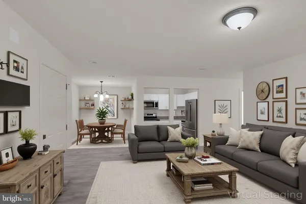 a living room with furniture and a dining room