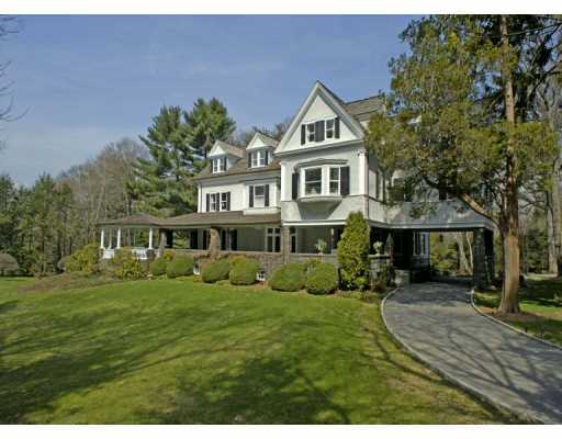 Undisclosed Address Greenwich, CT 06830 - Photo 1 of 7 a front view of a house with a garden