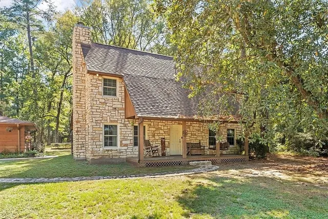 a view of a house with a yard and sitting area