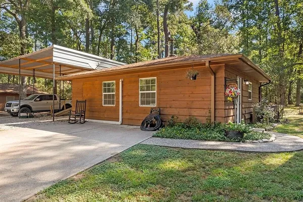 a backyard of a house with barbeque oven table and chairs