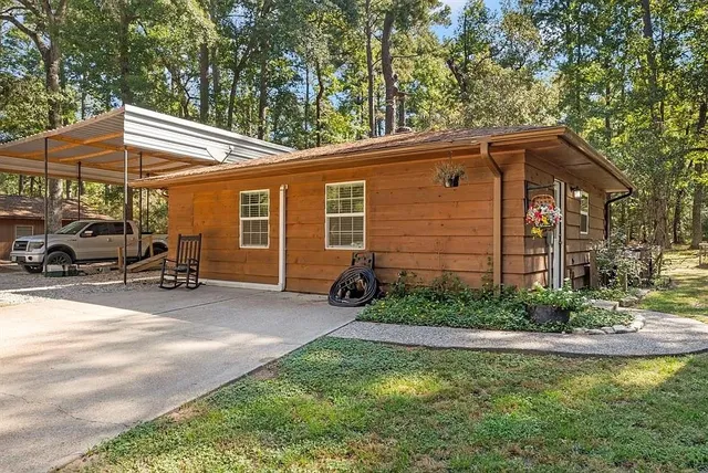 a backyard of a house with barbeque oven table and chairs