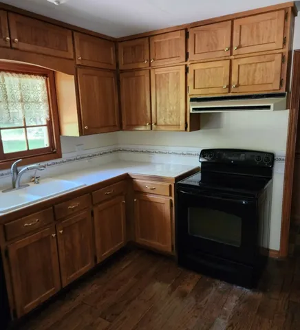 a kitchen with granite countertop cabinets stainless steel appliances and a sink