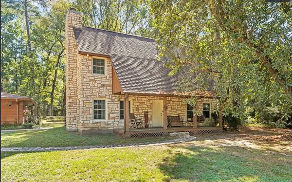 a view of a house with a yard and sitting area