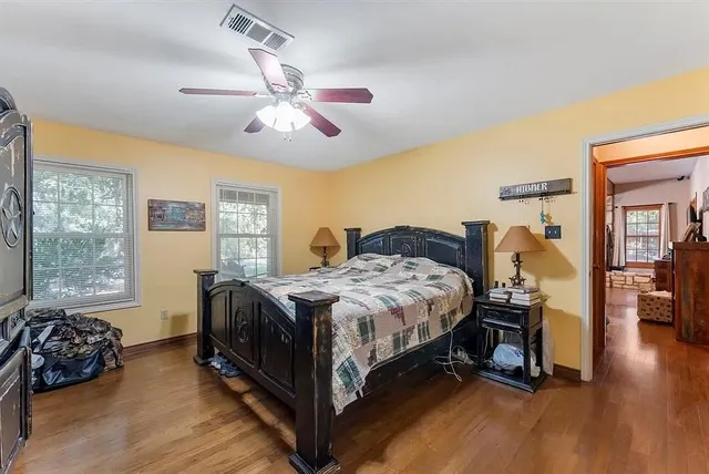 a bedroom with a bed and wooden floor