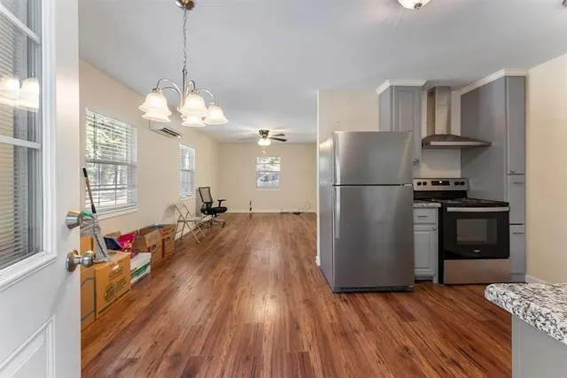 a kitchen with sink refrigerator and cabinets