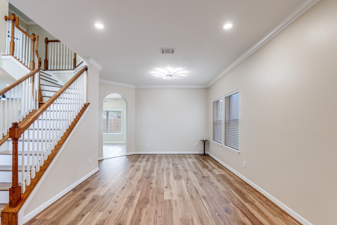 3231 Alabama Street Houston, TX 77004 - Photo 5 of 20 a view of hallway with stairs and wooden floor