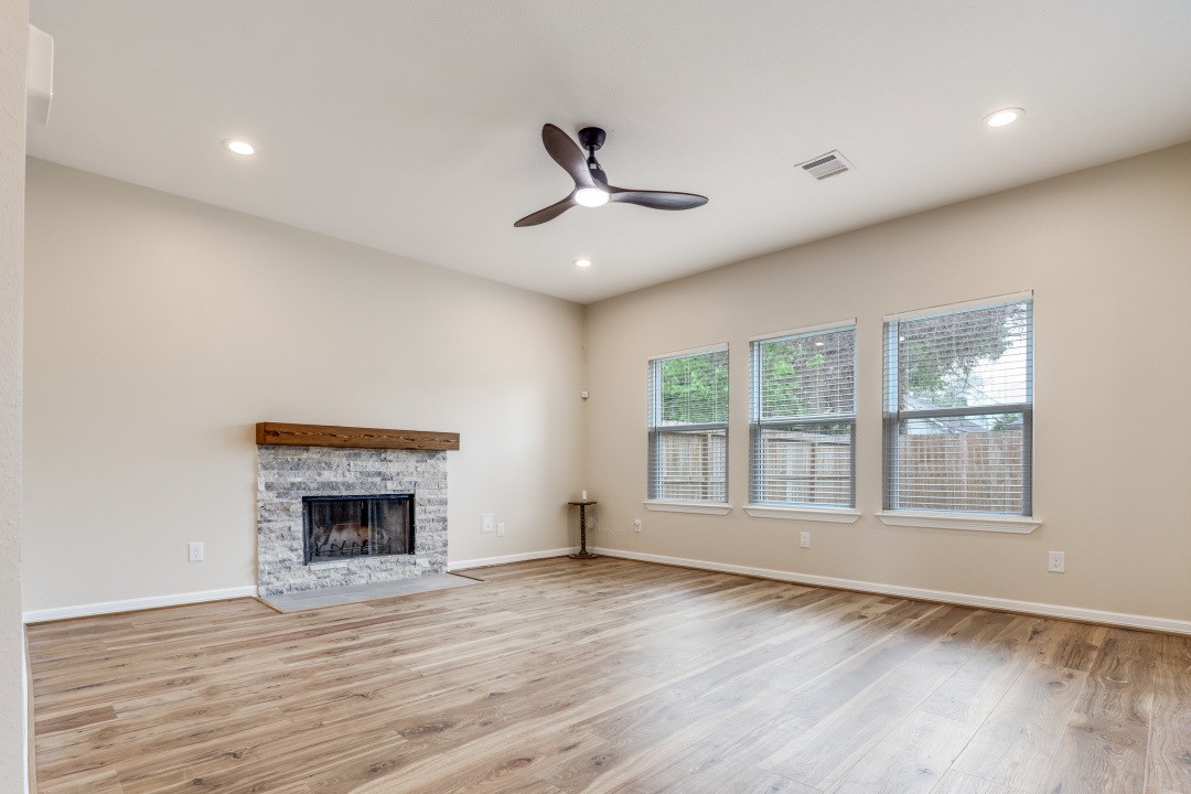 3231 Alabama Street Houston, TX 77004 - Photo 8 of 20 a view of an empty room with wooden floor and a window