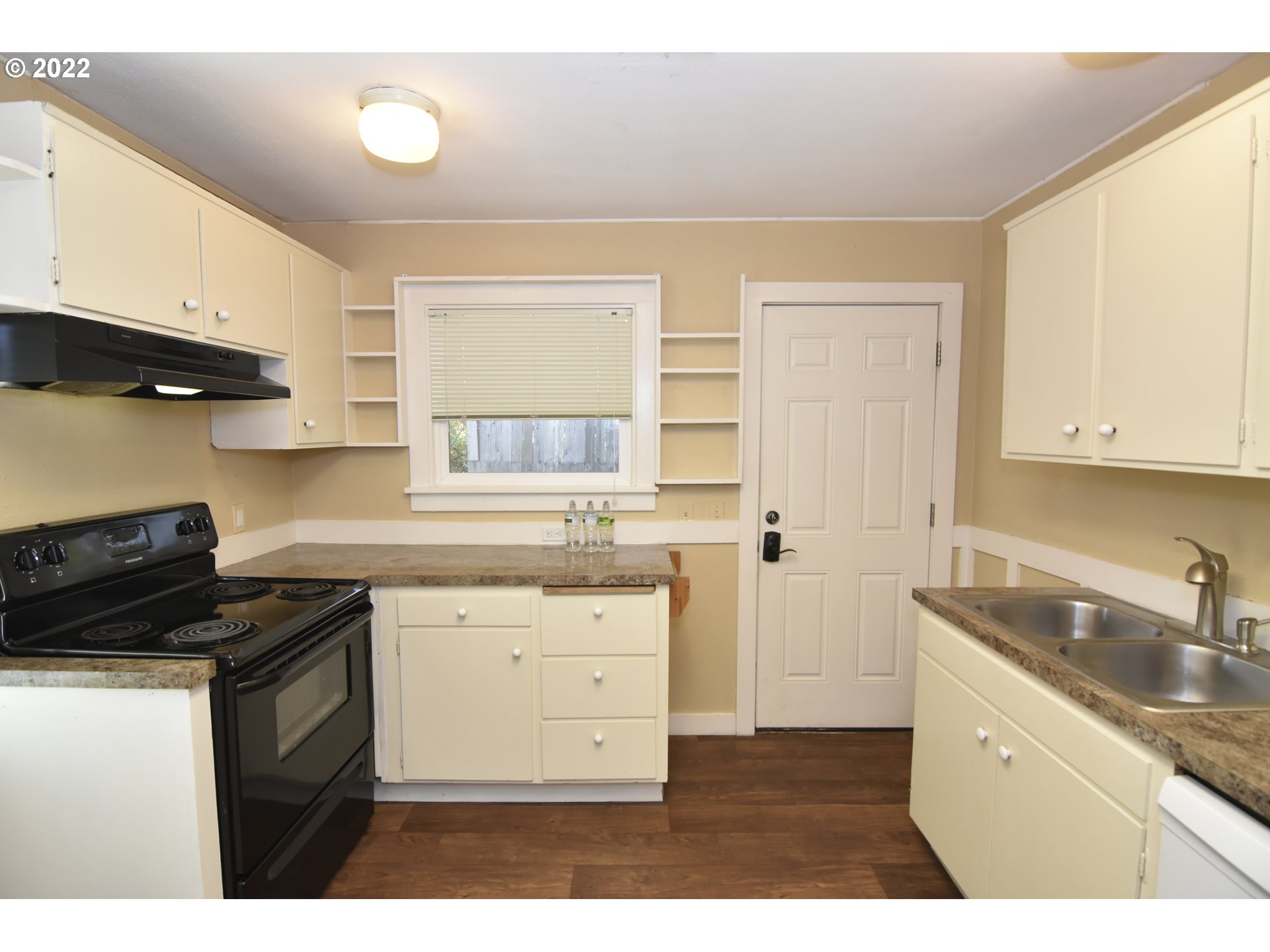 474 Broadway Street Springfield, OR 97477 - Photo 5 of 21 a kitchen with granite countertop a sink a stove and cabinets