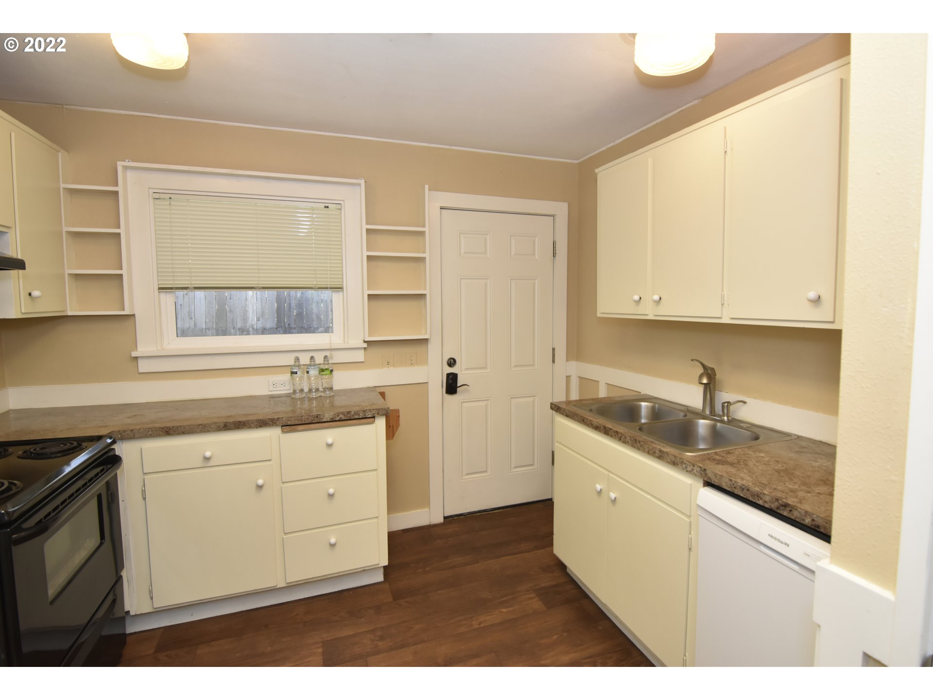 474 Broadway Street Springfield, OR 97477 - Photo 6 of 21 a kitchen with granite countertop white cabinets and white appliances
