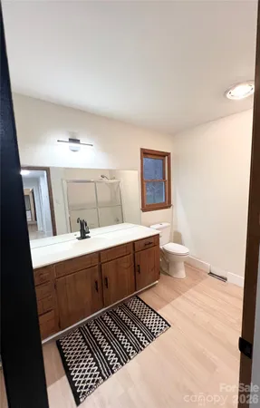 a spacious bathroom with a sink a mirror and a bathtub