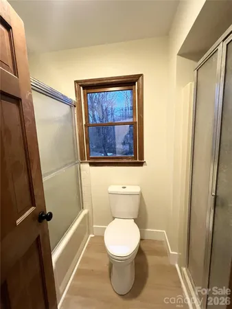 a white toilet sitting next to a small bathroom