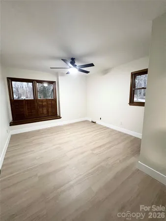 a view of empty room with a fireplace